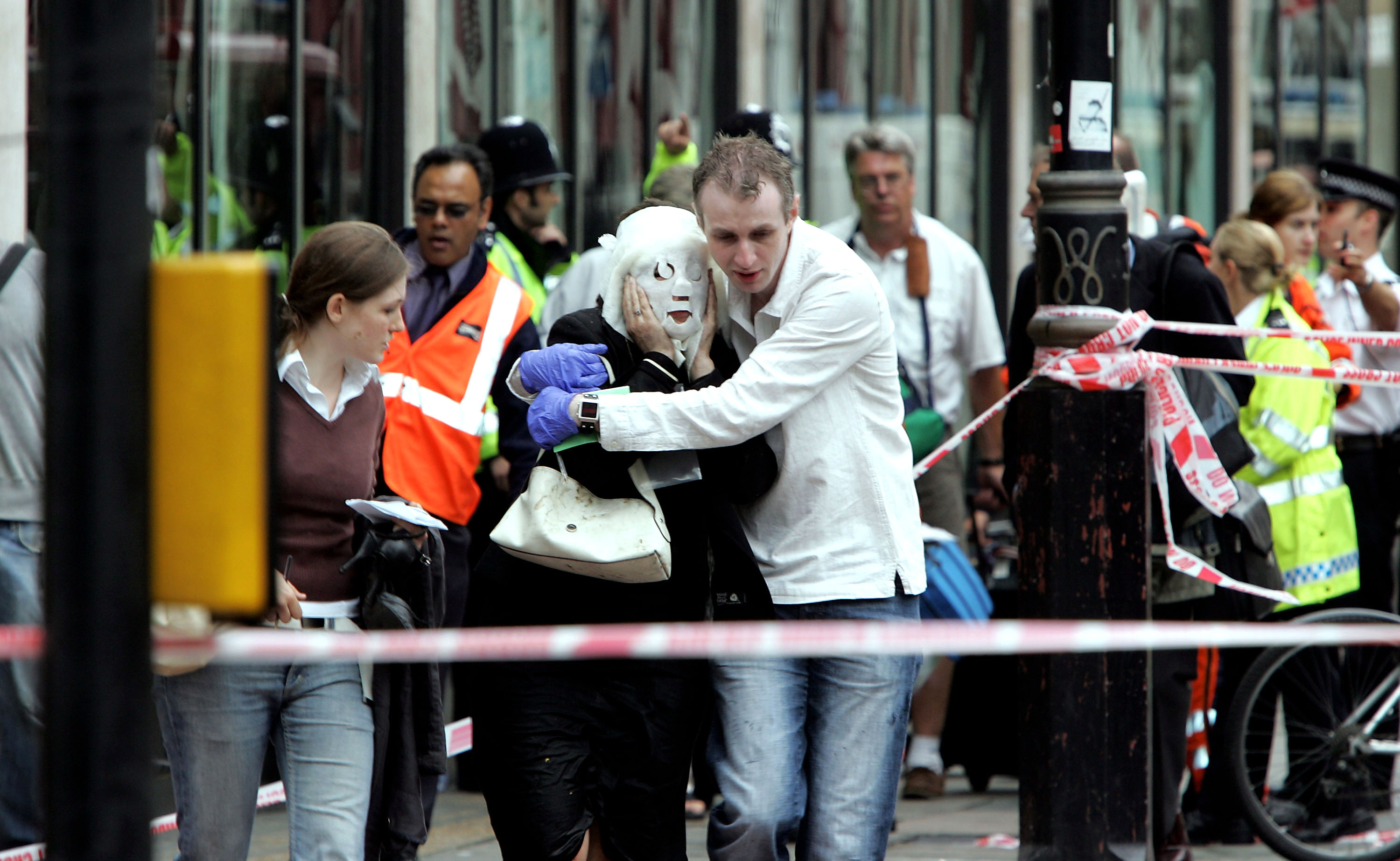 Survivors run to safety after bombs go off                         on the subway and a bus in London on July 7, 2005