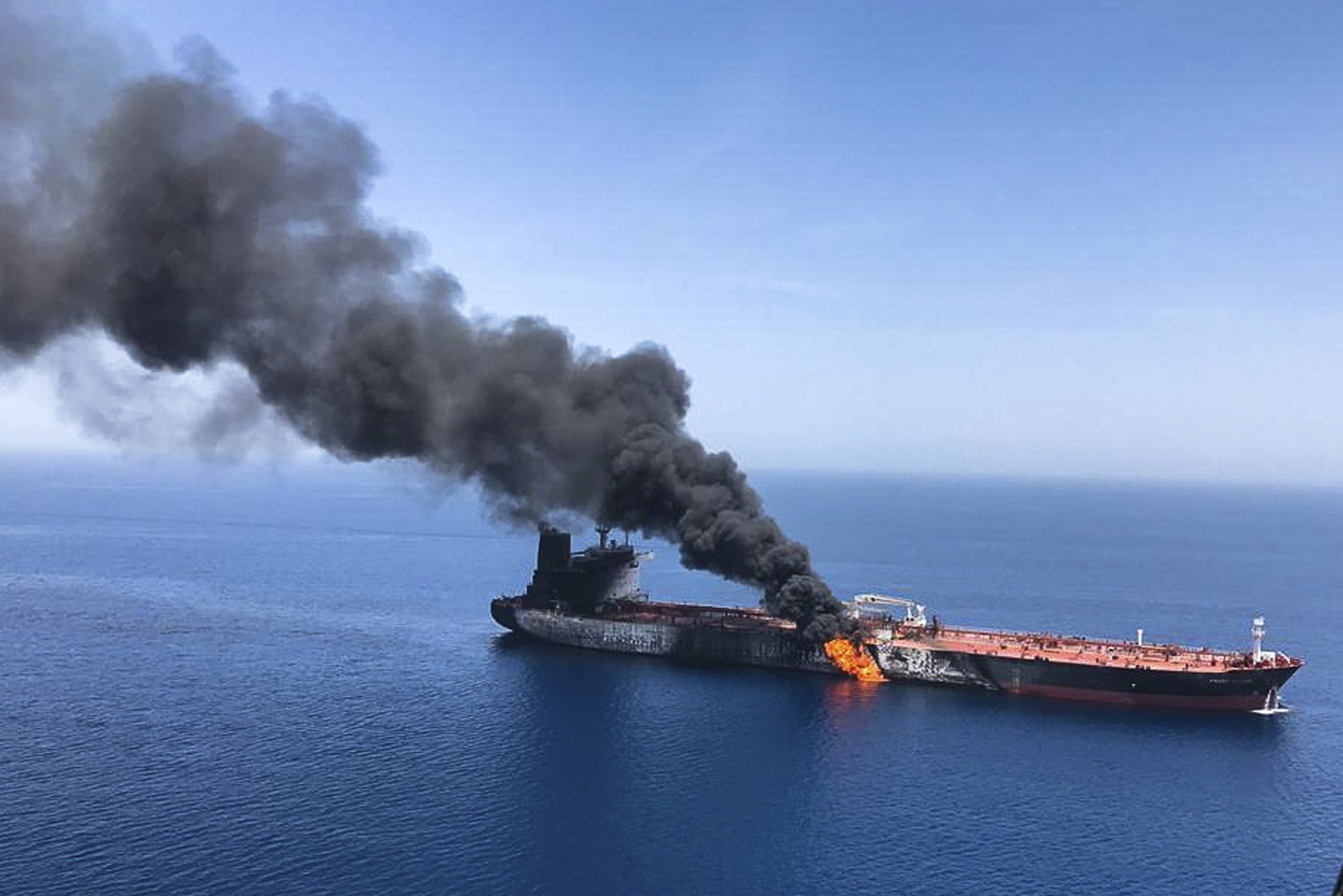 An oil tanker on fire in the sea of Oman last month