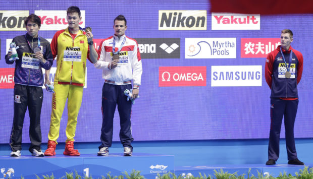 Duncan Scott, right stood away from the podium after the 200m freestyle