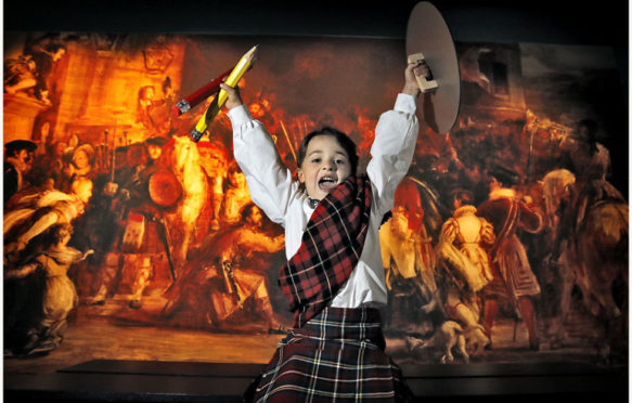 Adam Armitage dresses in tartan at the National Museum of Scotland’s Wild and Majestic: Romantic Visions of Scotland exhibition to highlight a series of associated family craft activities supported by players of People’s Postcode Lottery, which will run from 29 July - 2 August.