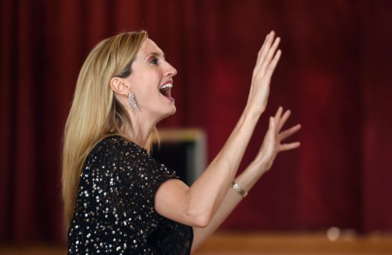 The BBC's Joy Dunlop conducts the choir in rehearsals.