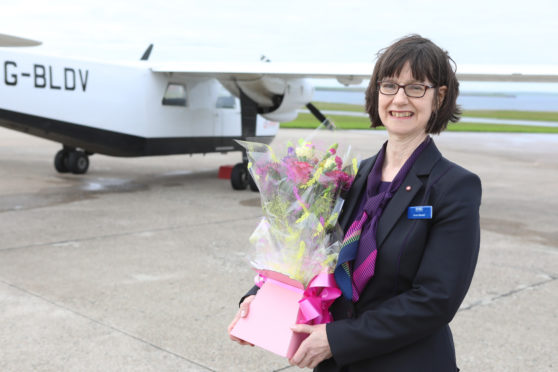 Anne Rendall with her gift as she celebrates retiring