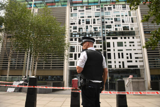 Police officers at government building in Marsham Street in Westminster, London after an incident in which a man was stabbed