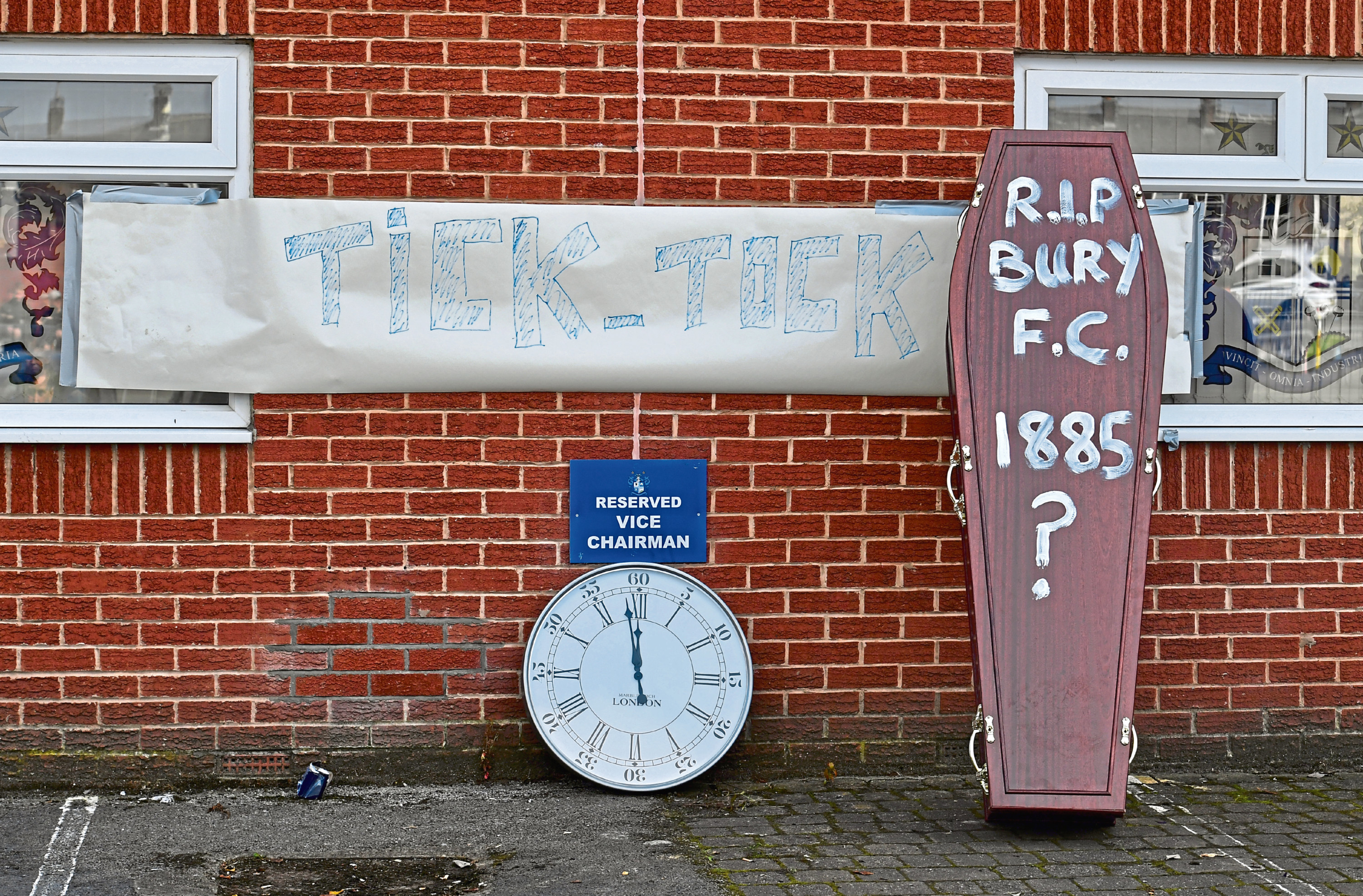 Bury fans deliver a symbolic coffin reading 'R.I.P Bury F.C. 1885 ?' and clock at Gigg Lane, home of Bury FC.
