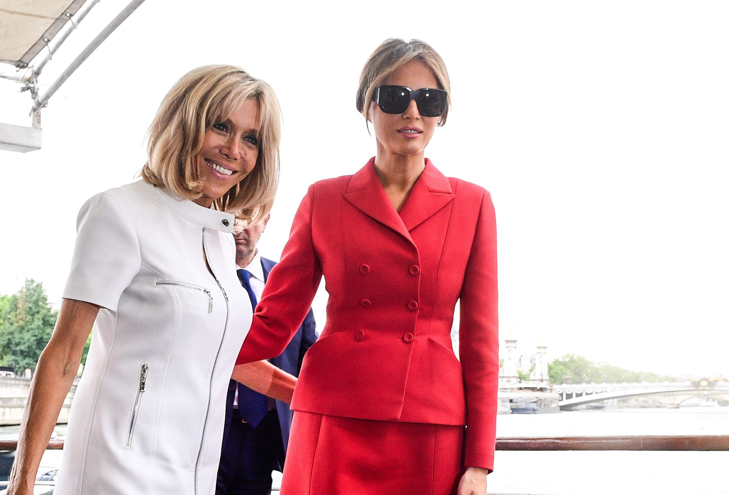 US First Lady Melania Trump (R) and French president's wife Brigitte Macron leave after a boat trip down the River Seine in Paris.