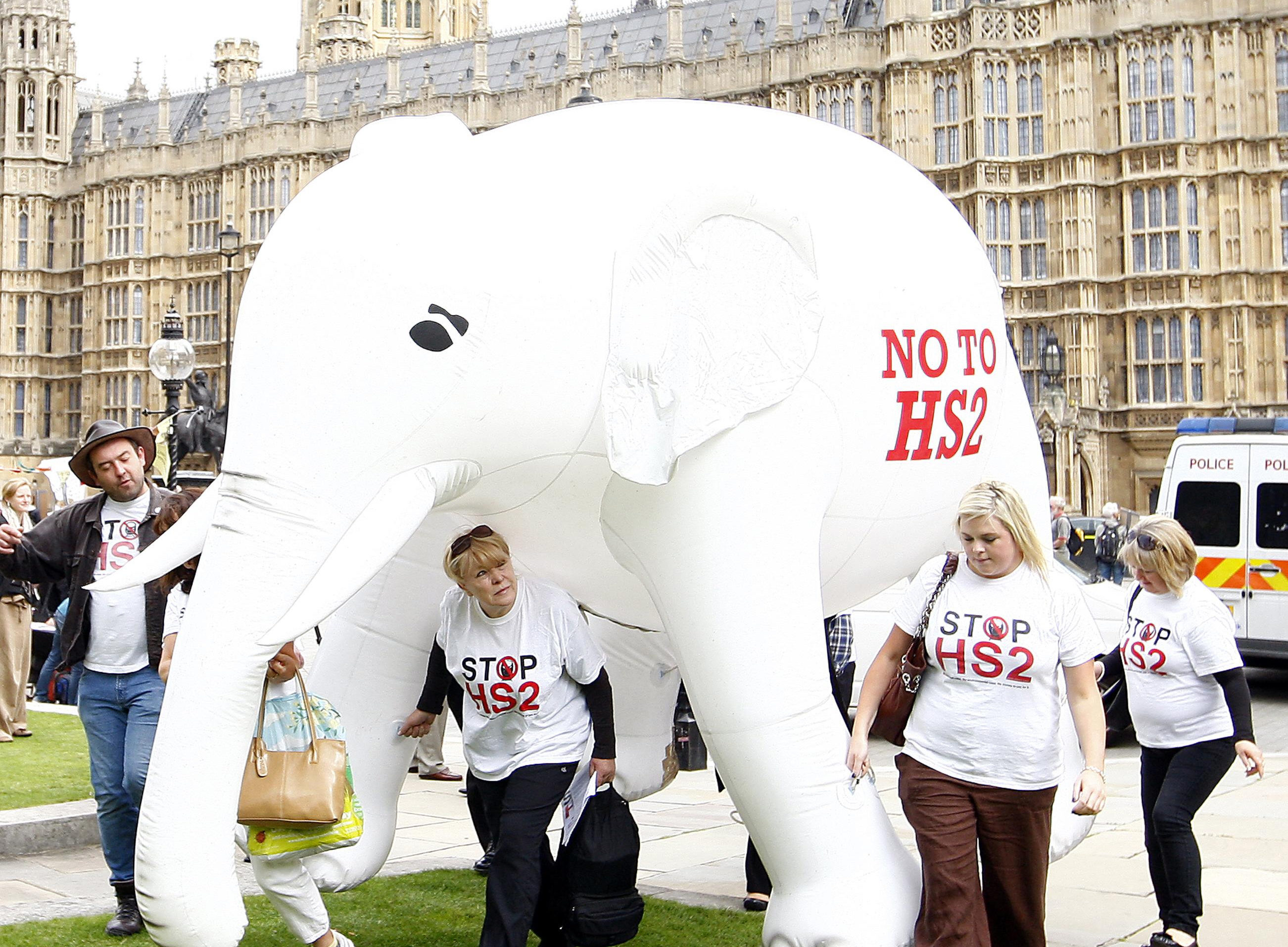 Members of STOP HS2 with their 10 foot high inflatable white elephant outside parliament, London, as both the Secretary of State for Transport Philip Hammond and the staff of HS2 Ltd give evidence to the Transport Select Committee inquiry of HS2, the proposed new high speed rail link.