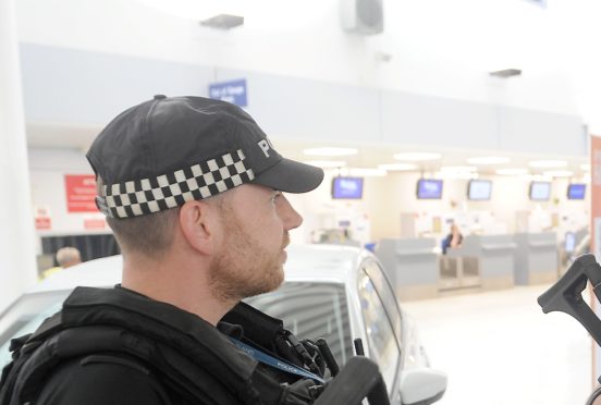 Armed Police wear unisex baseball caps.