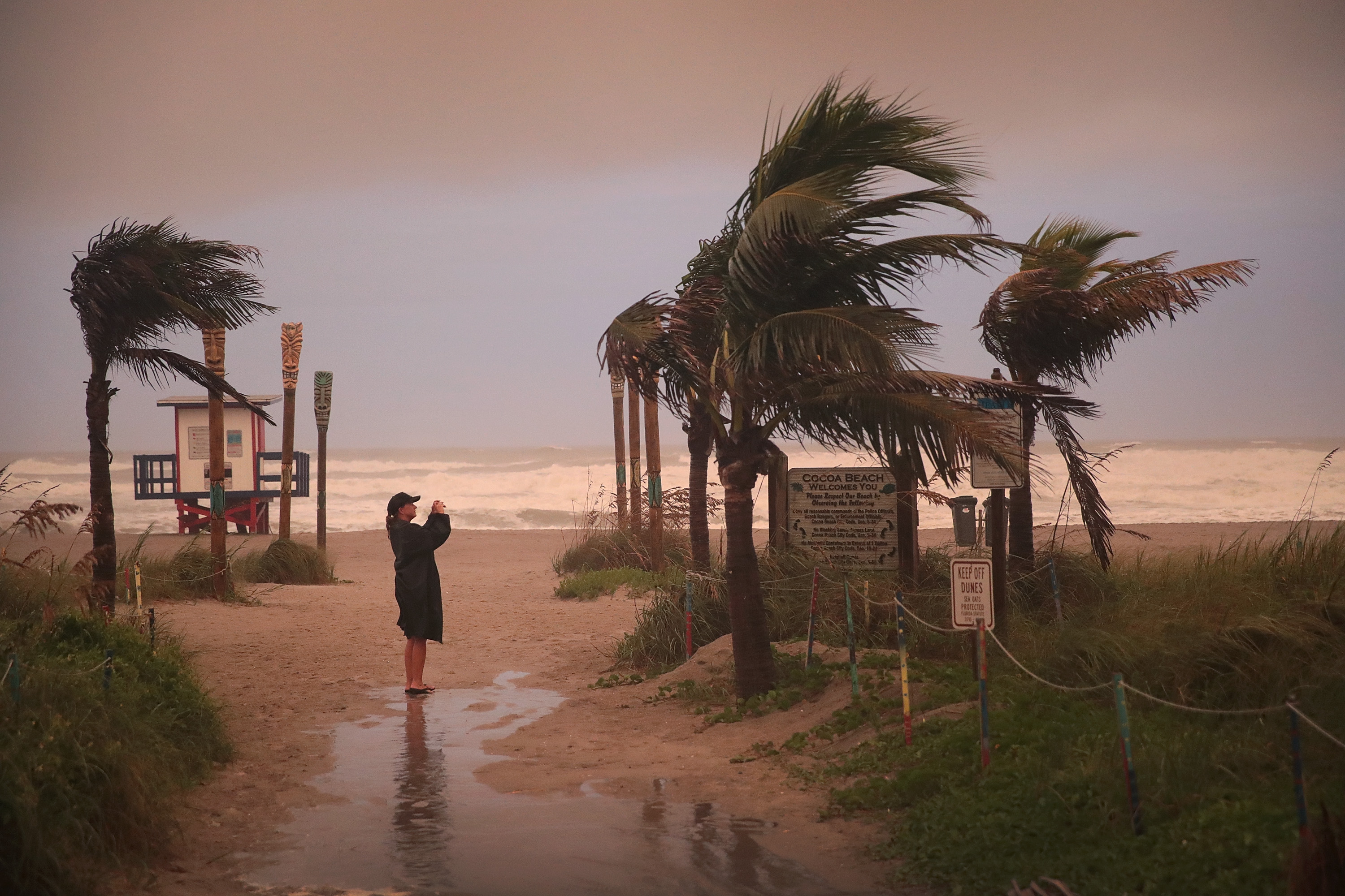 A woman on Cocoa Beach, Florida on Friday as Hurricane Dorian hits