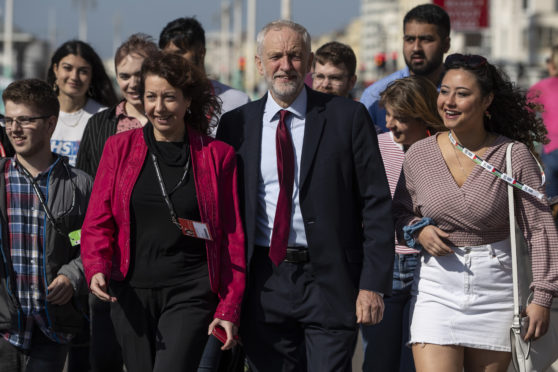 Labour leader, Jeremy Corbyn and Brighton Council leader, Nancy Platt walk with young party members along Brighton Promenade for a staged arrival picture ahead of the 2019 Labour Party Conference on September 19, 2019 in Brighton, England.