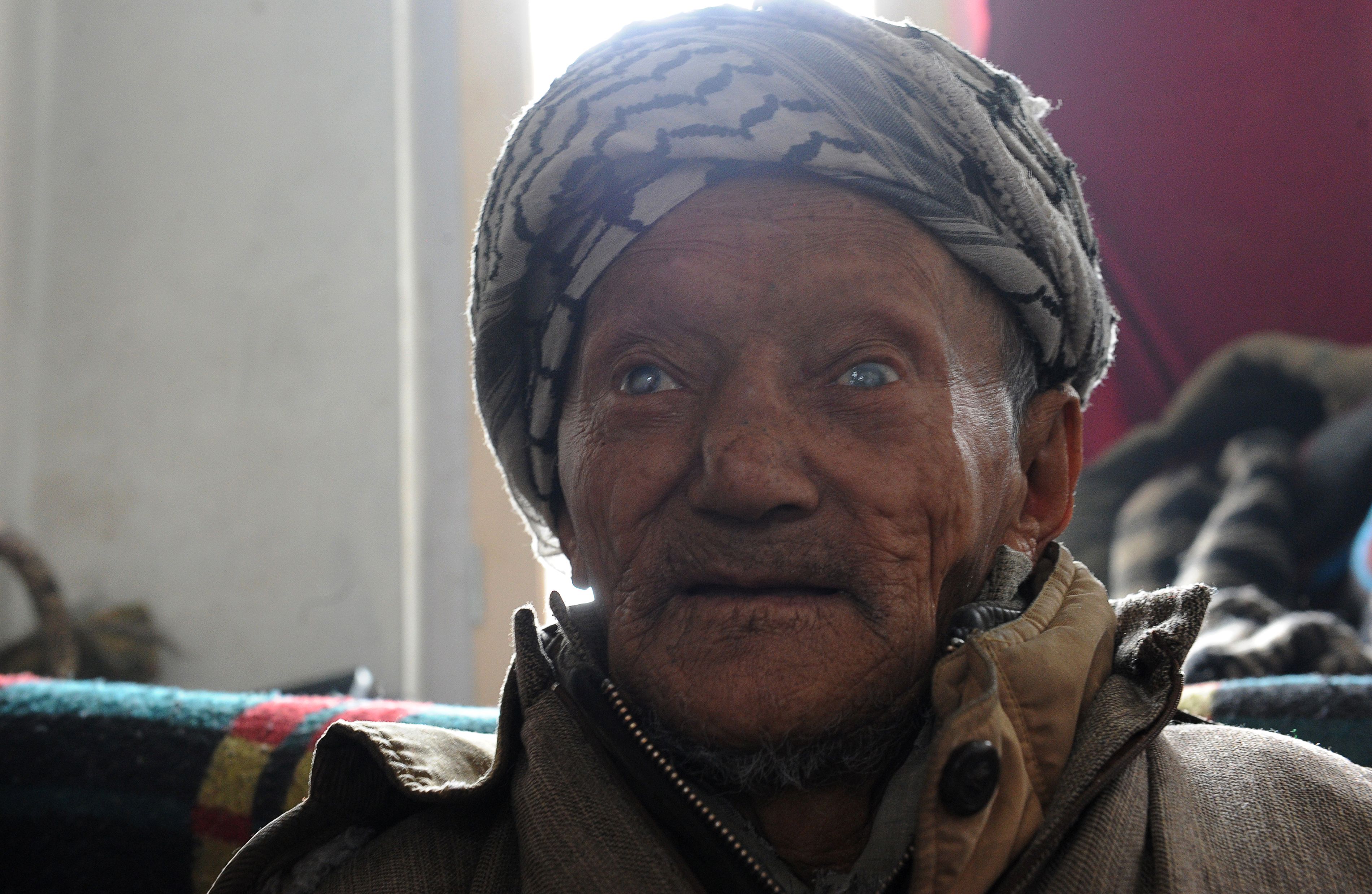 A leprosy patient sits in his room at the leprosy hospital in downtown Srinagarto.