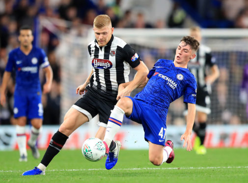 Grimsby Town's Eliott Whitehouse (left) and Chelsea's Billy Gilmour battle for the ball during the Carabao Cup, Third Round match at Stamford Bridge
