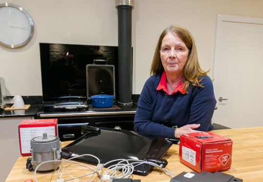 Ruth Patience in her Highland home with some of the spare parts and cabling from heating system