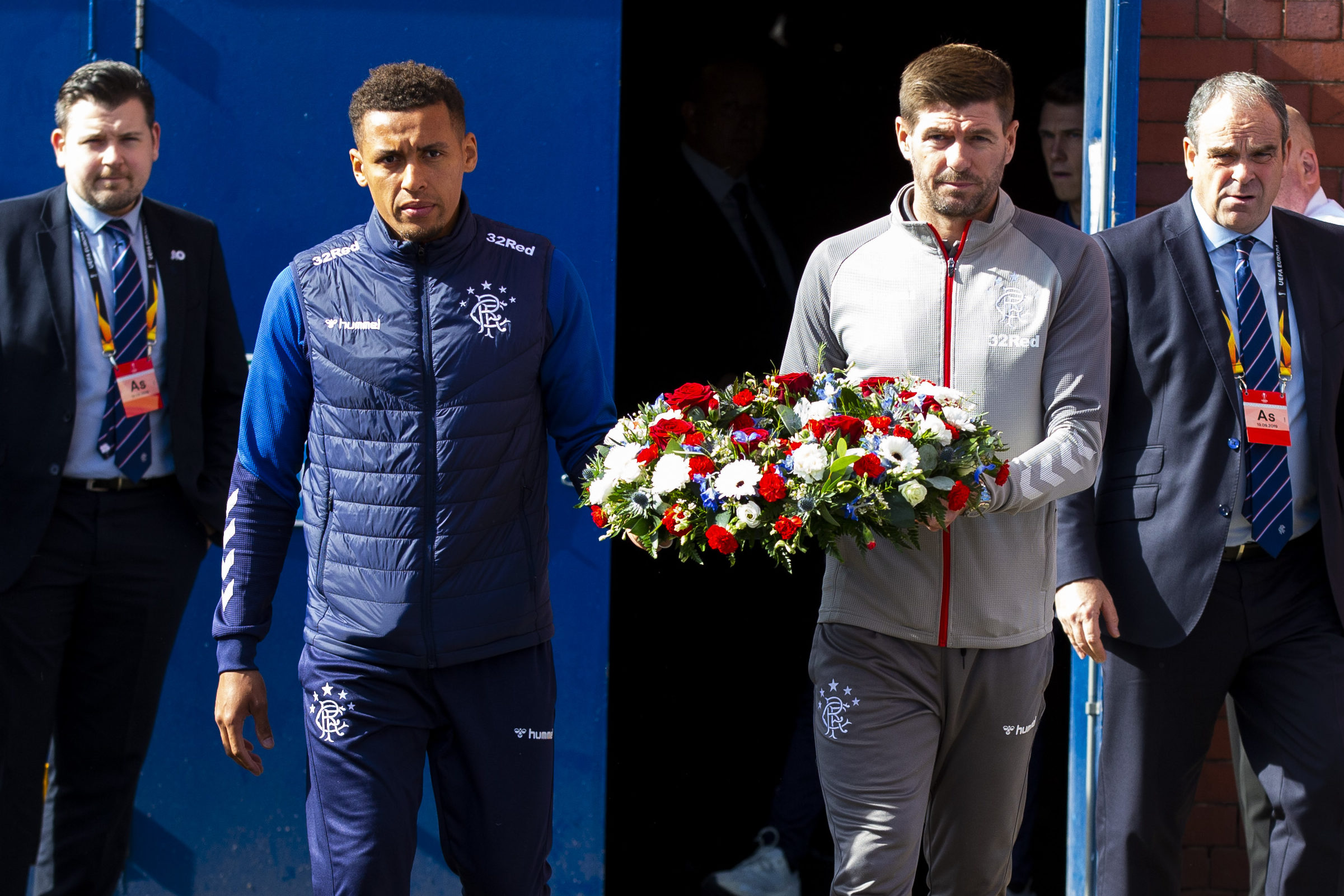 James Tavernier and Steven Gerrard carry the wreath