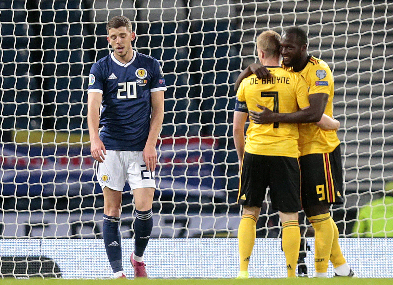 Scotland's Ryan Christie (left) after Belgium's Romelu Lukaku celebrates scoring with Kevin De Bruyne