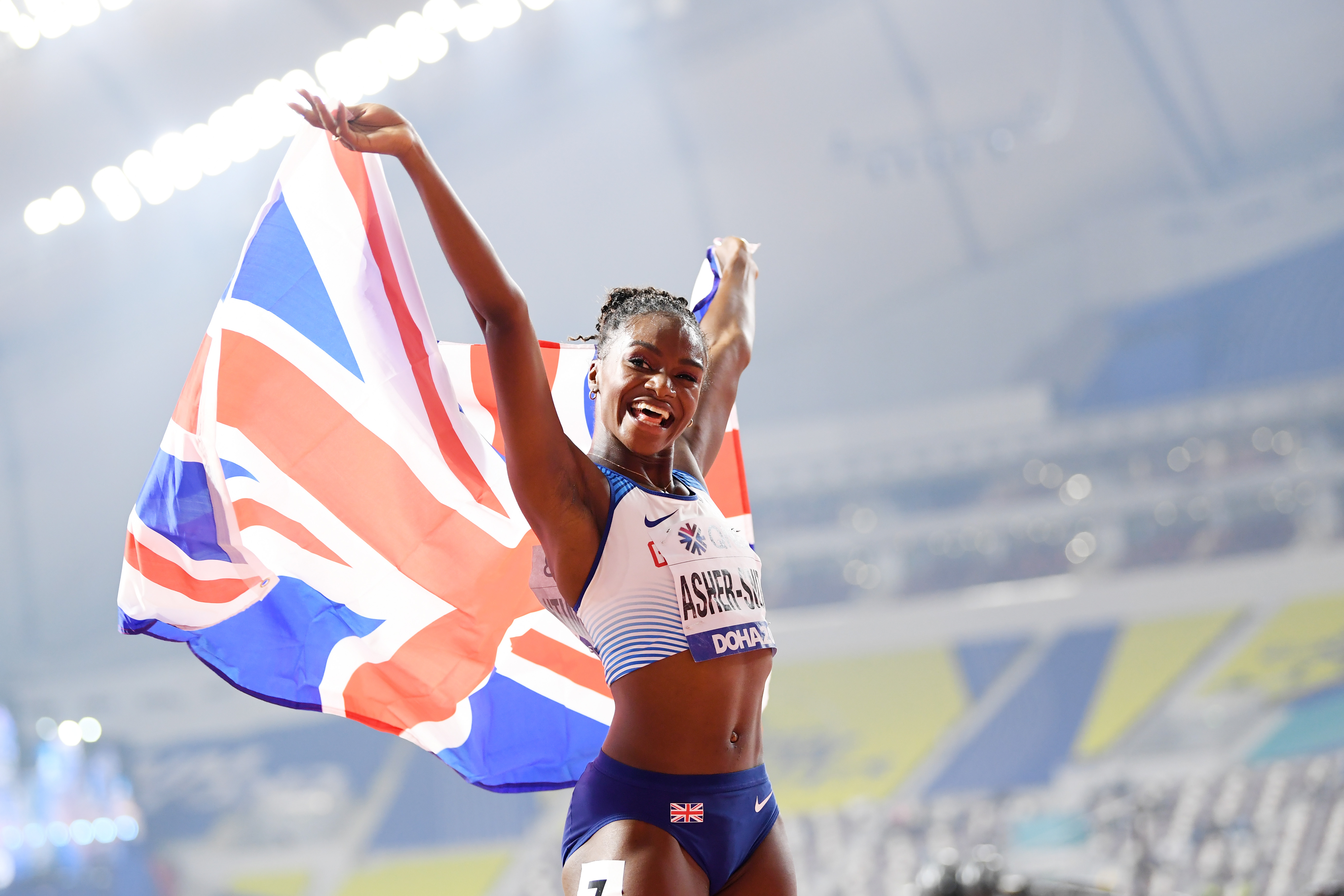 Dina Asher-Smith of Great Britain celebrates after winning gold in the Women's 200 metres final