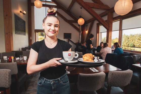 Rebecca McCue, offering a delicious, plump scone,                  and a cuppa, ensures our hungry Spy heads away happy