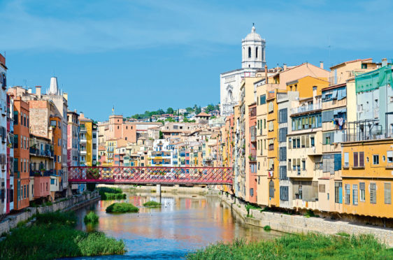 View of Eiffel Bridge (Puente Eiffel, or Pont de les Peixateries Velles) across Onyar River, Cathedral and buildings in historical center of Girona, Spain