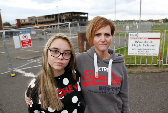 Caroline Taylor and daughter Hannah outside fire damaged Woodmill school in Dunfermline
