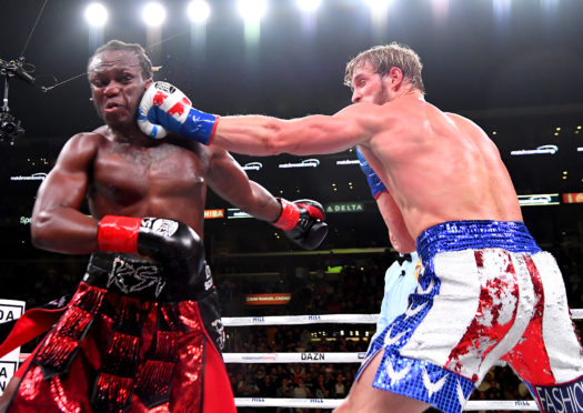 Logan Paul (red/white/blue shorts) and KSI (black/red shorts) exchange punches during their pro debut fight at Staples Center on November 9, 2019 in Los Angeles, California. KSI won by decision.