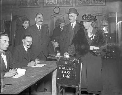 Mrs Mawbey is the first person to cast her vote at a polling station in Dulwich, south London, during the UK general election, 6th December 1923. (Photo by Topical Press Agency/Hulton Archive/Getty Images)