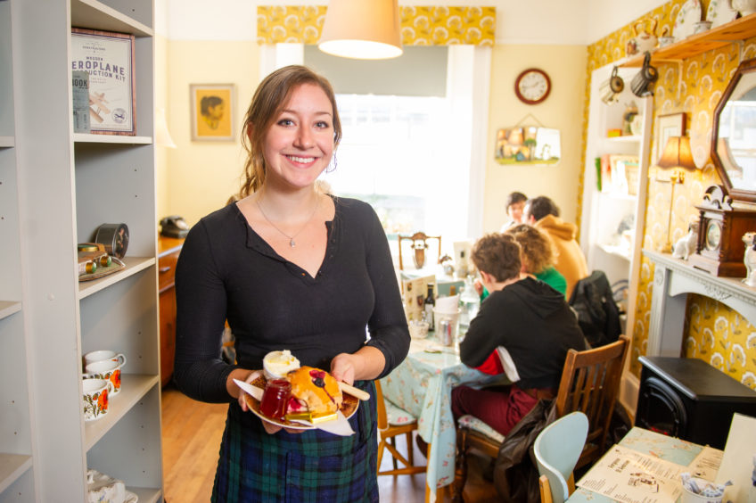 Claire Wever with one of the cafe's signature Prince of Cambridge scones