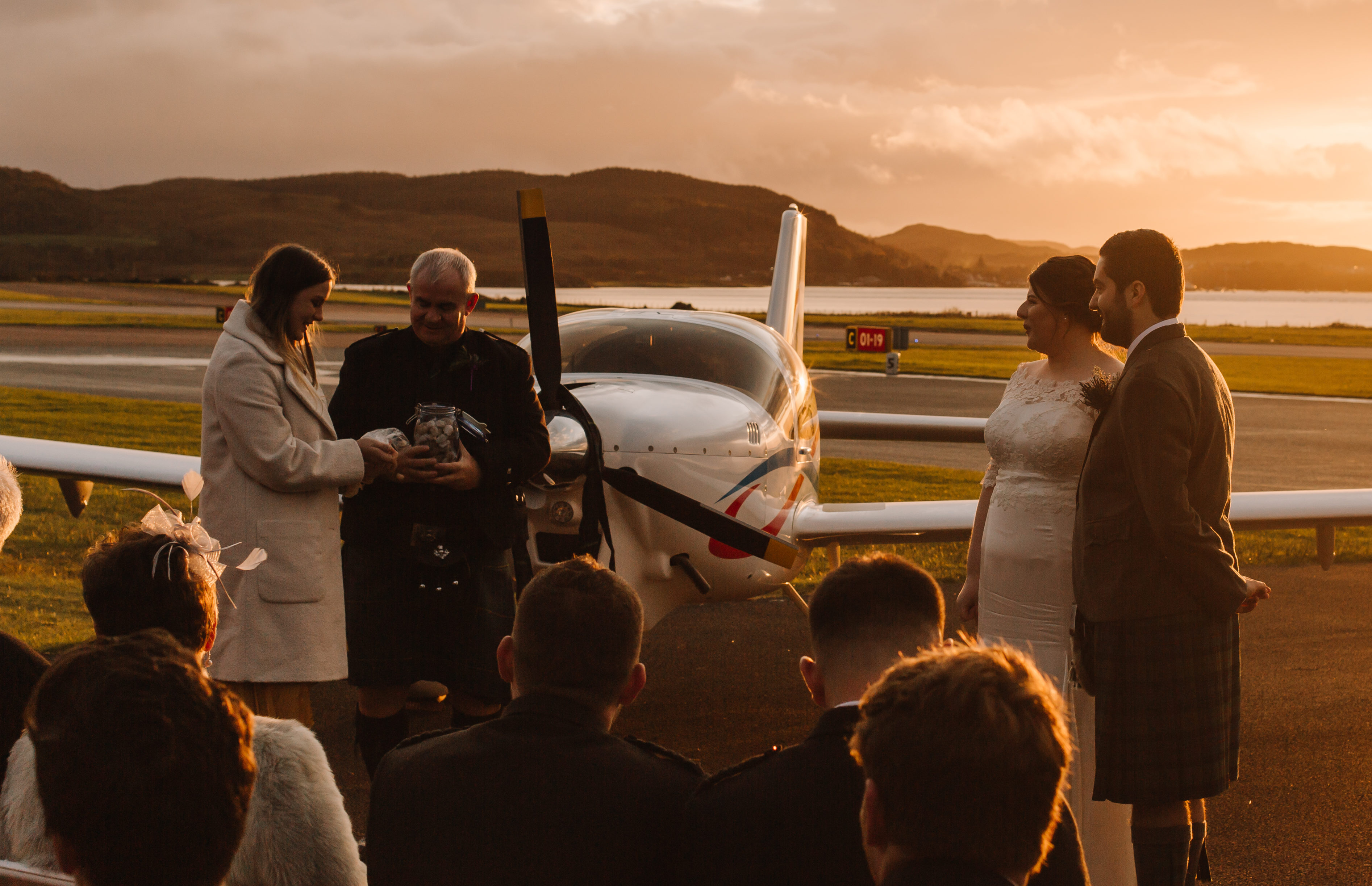 Groom’s cousin, Sophie, and uncle, Mark, collect wishing stones as air traffic controller Lizzie Farrell                       and pilot Danny Fleming tie the knot at Oban Airport