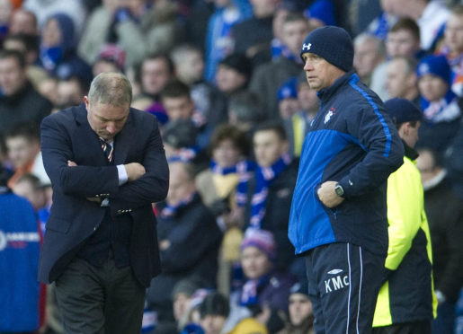 Rangers manager Ally McCoist looks to the turf as assistant Kenny McDowall (right) looks on