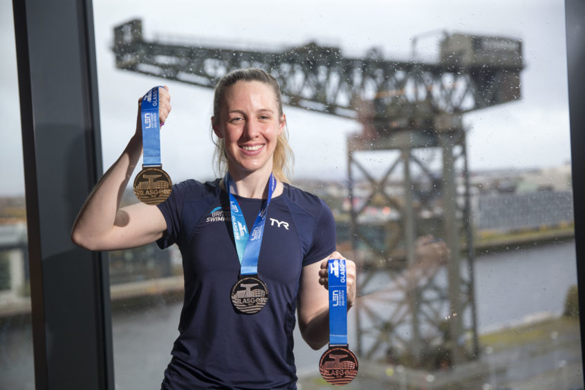 Hannah with the medals, which feature the iconic Finnieston Crane