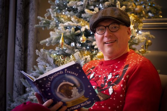 Alexander McCabe with his book, The Christmas Present.