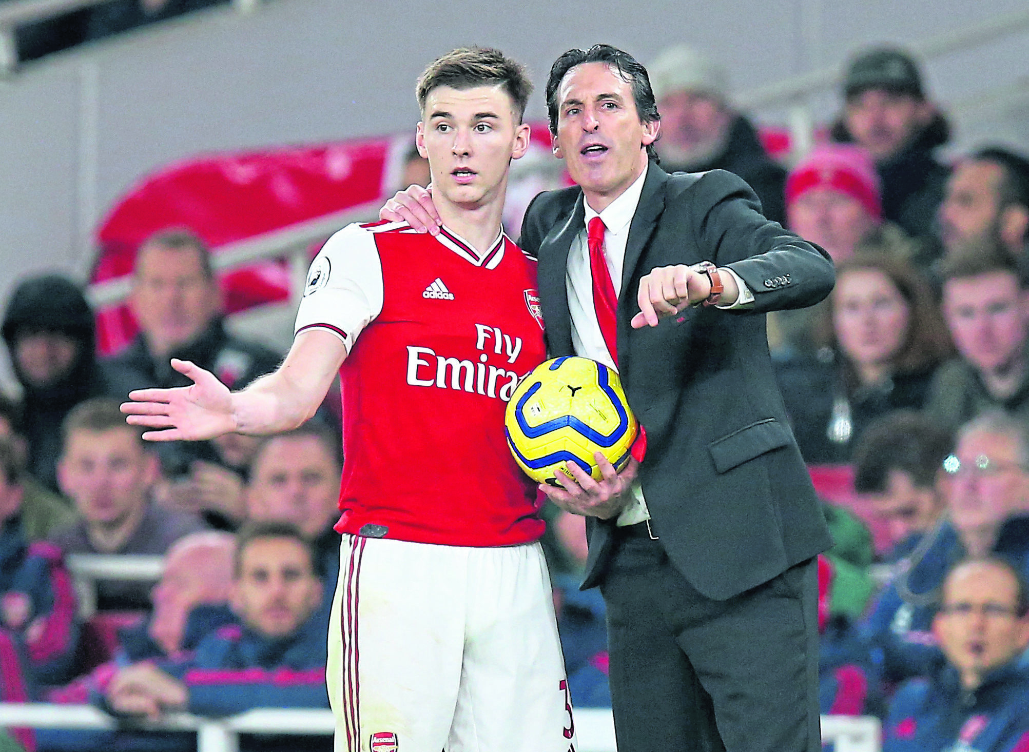 Arsenal manager Unai Emery holds the match ball and talks to Kieran Tierney during the Premier League match between Arsenal FC and Southampton FC at Emirates Stadium on November 23, 2019 in London, United Kingdom.