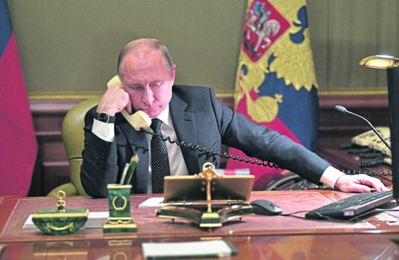 Vladimir Putin, putting in a call from his office in Moscow, has been accused of complicity