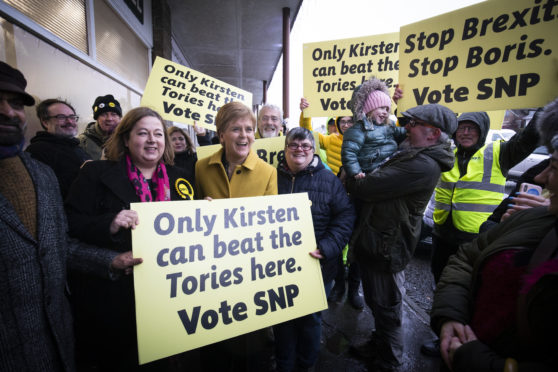 SNP leader Nicola Sturgeon with SNP candidate Kirsten Oswald (left), meets local party supporters during a visit to the Orry Mill, Glasgow, while on the General Election campaign trail.
