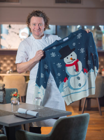 Chef Tom Kitchen in his Edinburgh restaurant The Kitchin with a Christmas jumper for Save the Children Christmas jumper appeal.