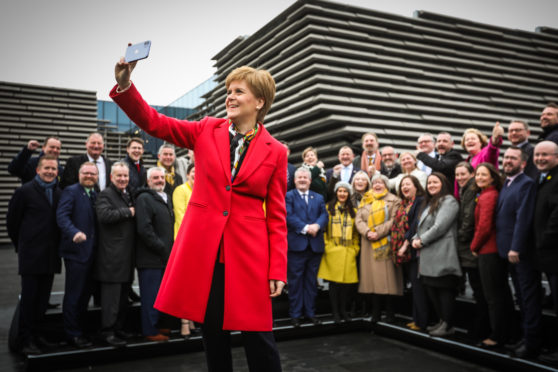 Nicola Sturgeon celebrates with the SNP's elected MPs