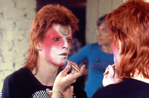David Bowie applying his alter-ego make-up in 1973