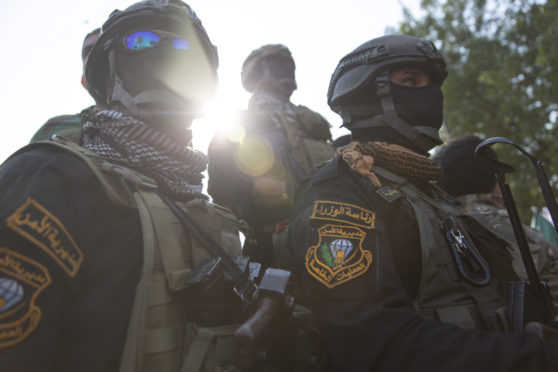 Iraqi security forces at one of the funerals yesterday