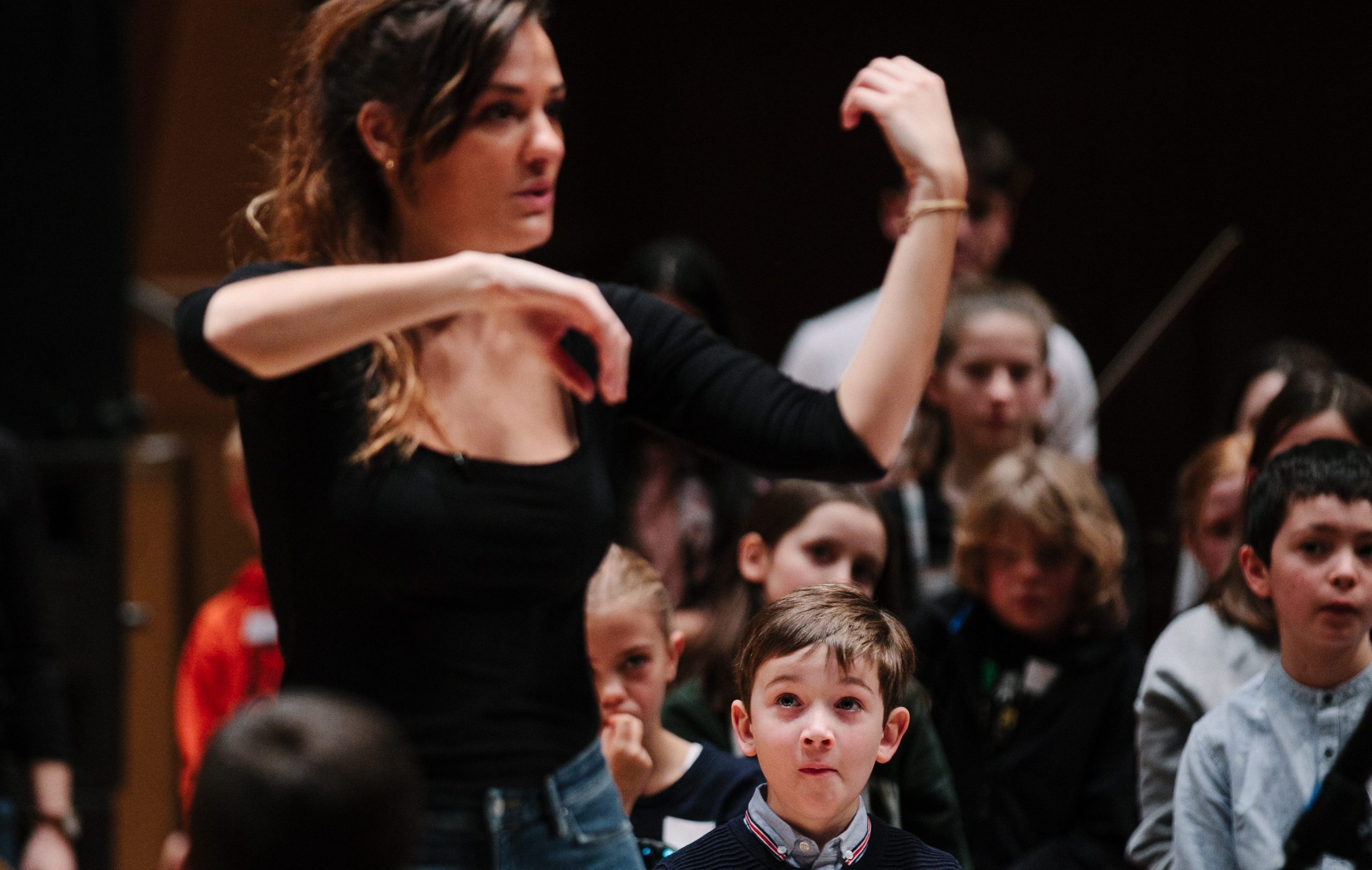 A young musician looks impressed as Nicola Benedetti offers expert tuition