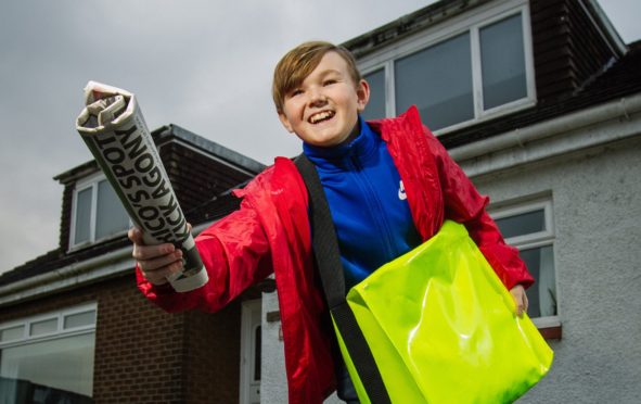 Paperboy Arryn Embleton, 12, delivering the news to neighbours in Alexandria
