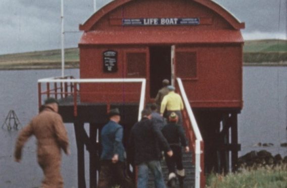 The Longhope crew rush to the lifeboat in 1964