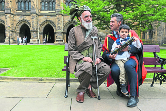 The special moment the head of the Scottish Refugee Council collected his honorary doctorate in front of his father despite him previously being denied entry to the UK.