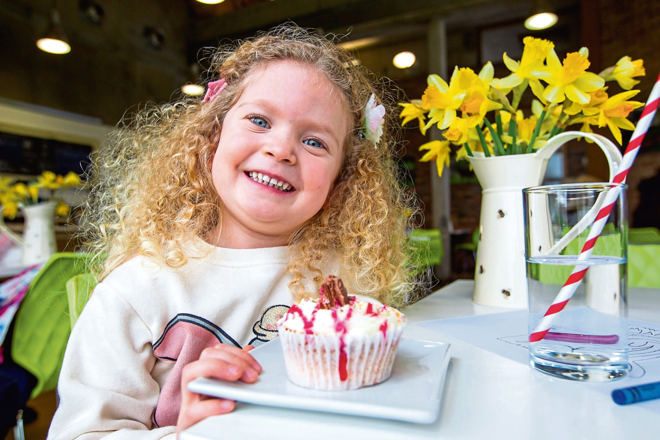 Wee Isabella has a big smile as she is about to enjoy a scrummy-looking cupcake at the Museum Of Rural life