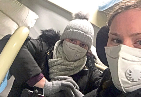 Jodi Carr and mum Alison wear masks on the train from Tianjin to Shanghai