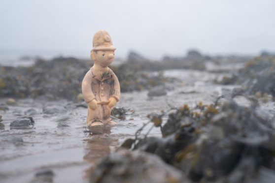 The plastic figure of Camberwick Green’s PC McGarry on the beach at Torryburn after being in the sea for decades