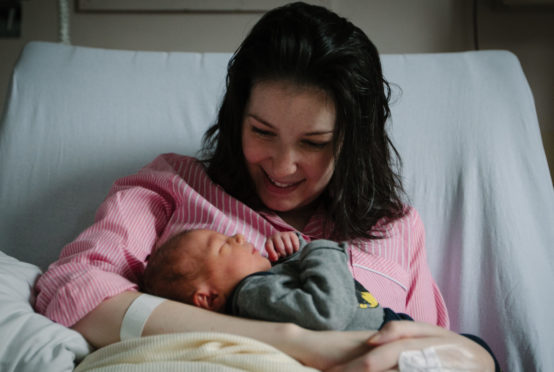 Brave new mum Lucy Lintott cuddles little son LJ in maternity ward