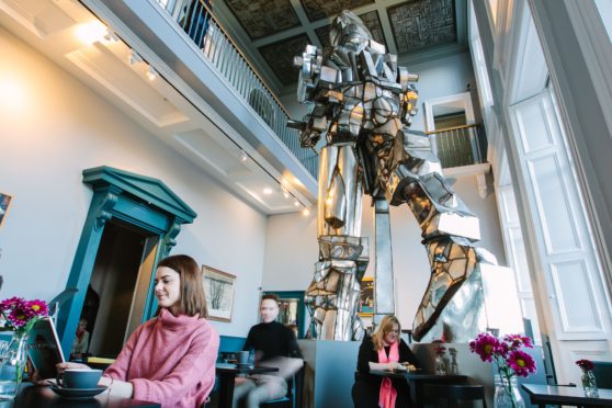 Eat long and prosper? Paolozzi’s huge Vulcan statue looms over diners in the cafe named after the great artist