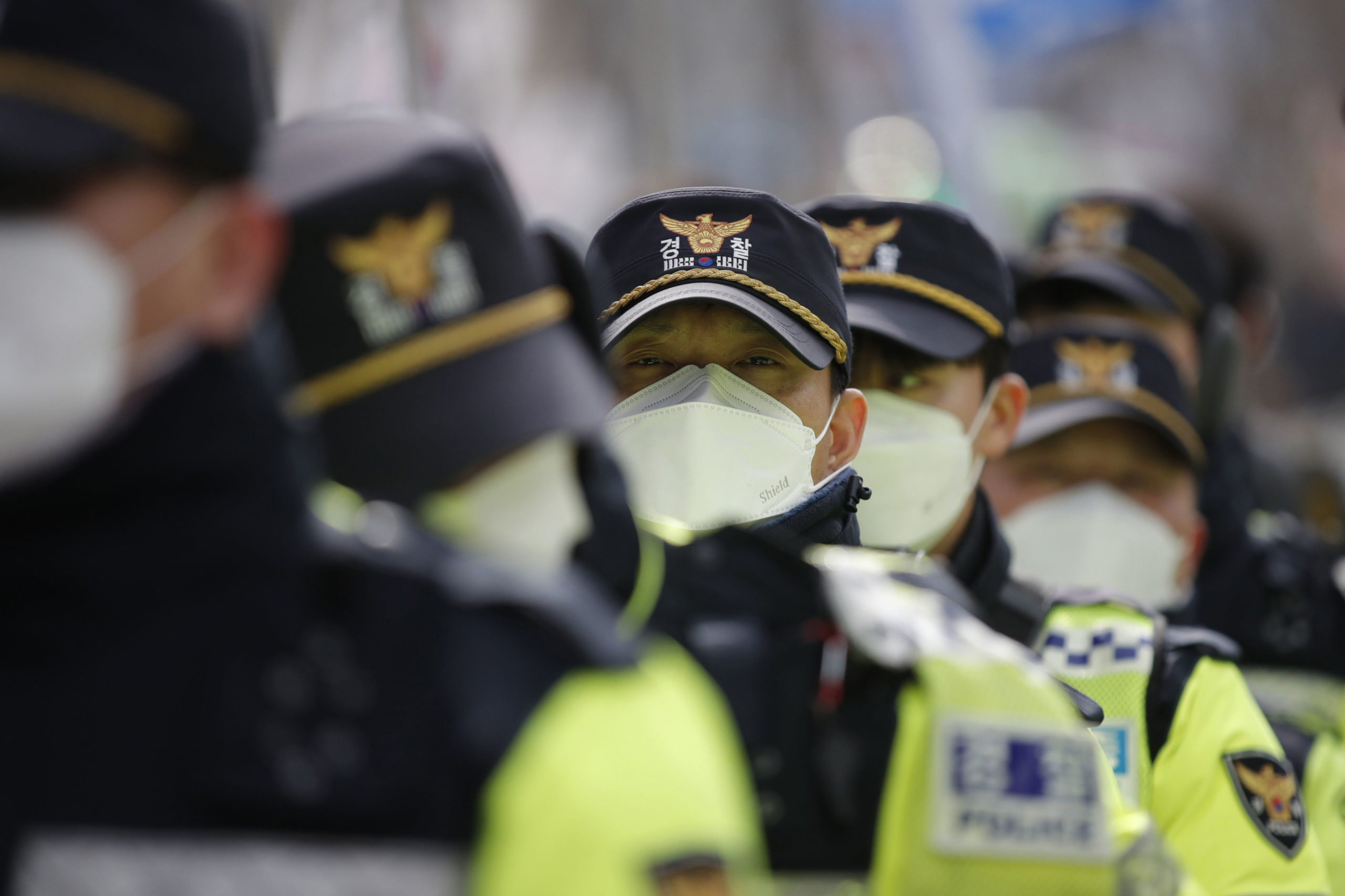 Masked police in Seoul, South Korea yesterday