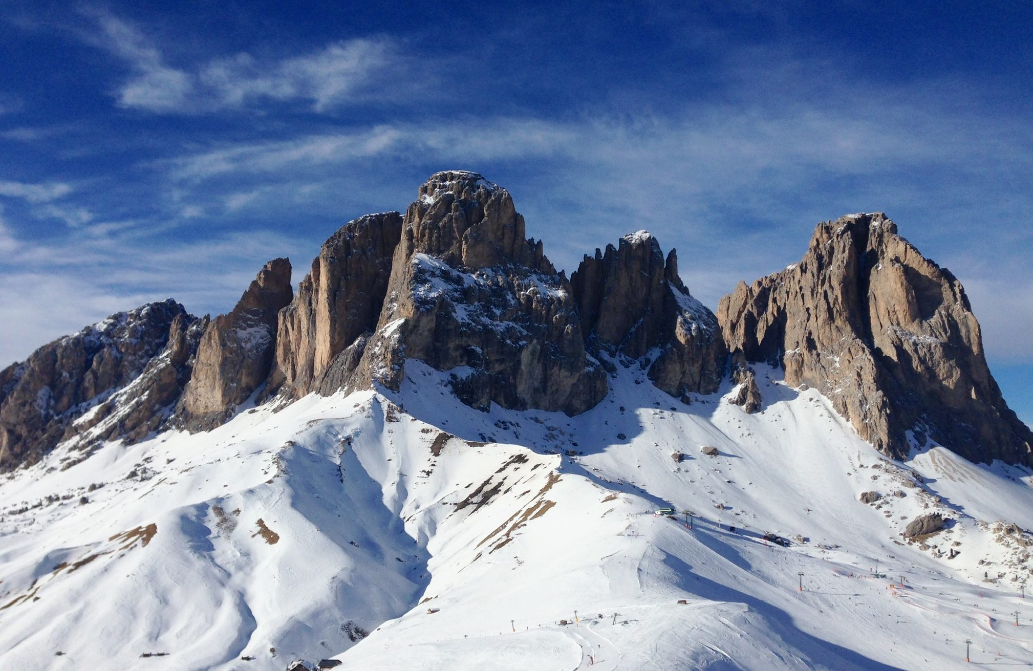 The spectacular jagged peaks of the Dolomites tower over so many fantastic ski runs