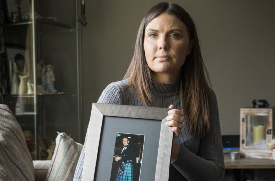 Natalie McKeown with a photograph of her father John Woods