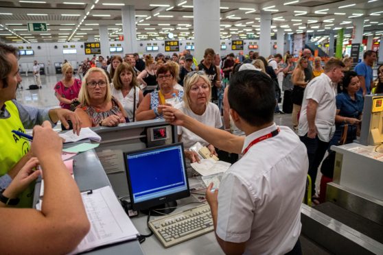 Stranded tourists whose flights were cancelled await help at Palma Airport near Mallorca after Thomas Cook’s collapse last September