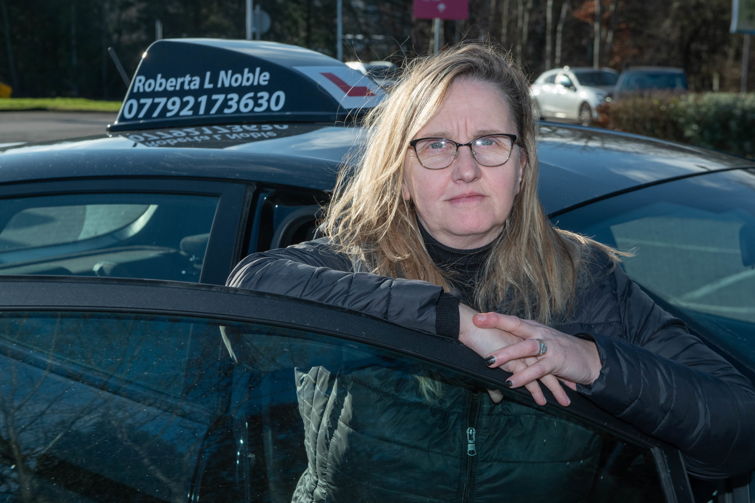 Driving instructor Roberta Noble with her new car in Aberdeen